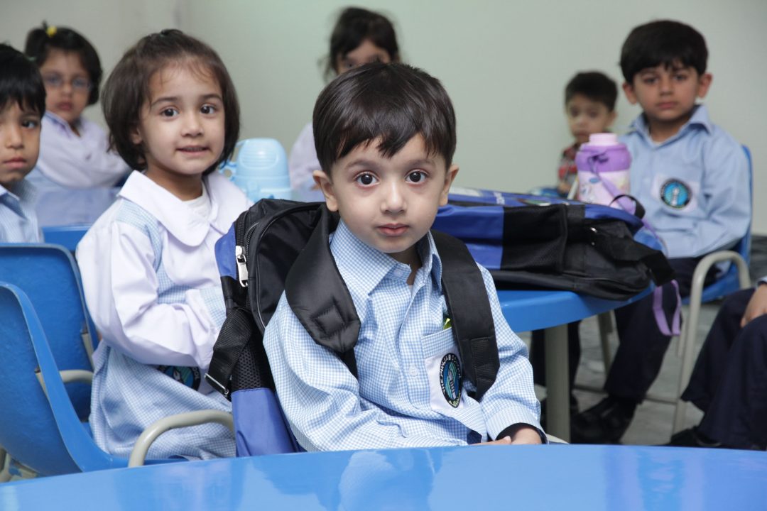 Young students of The Punjab School smiling in their classroom